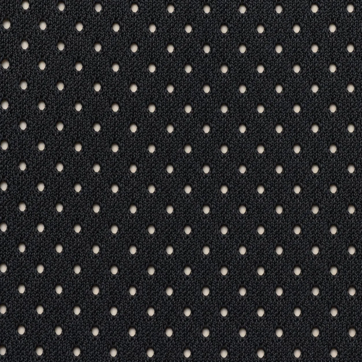 Close-up of black athletic mesh with small round holes